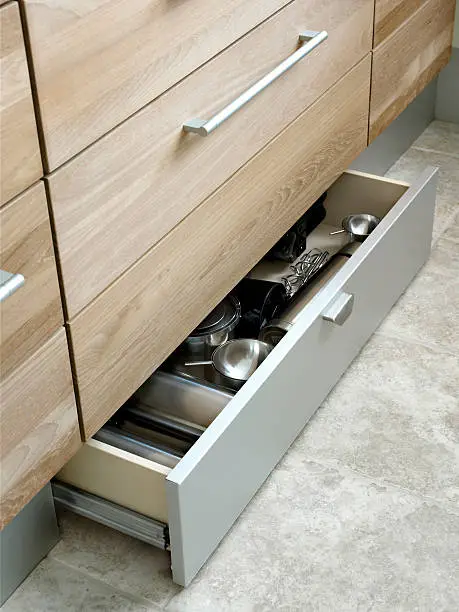 Drawer in a very modern kitchen full of stuff.