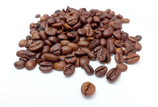 Bunch of coffee beans isolated on white background close up