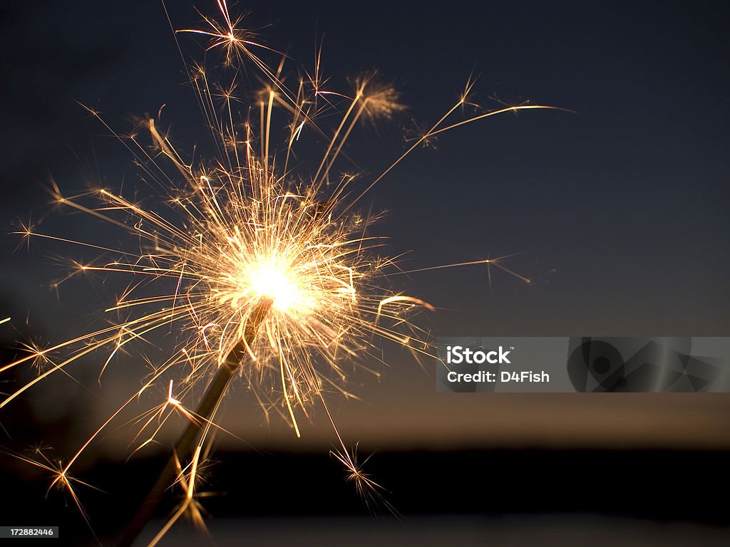 Sparkler A Lit Sparkler After Dusk With Lake and Horizon in Background Firework - Explosive Material Stock Photo