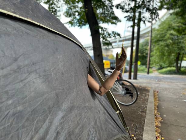 istock Homeless tent with mannequin arm 1728829317