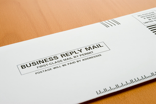 A business reply envelope on a desktop