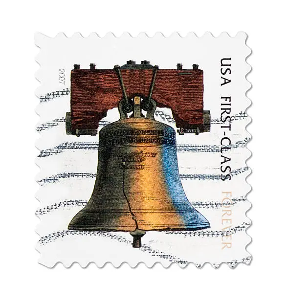 The United States Forever postage stamp can be used forever, regardless of postage price changes.  With postmark, Isolated on white.
