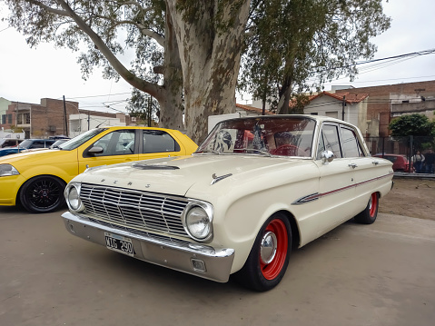 Lanús, Argentina - Sept 23, 2023: Old white 1964 Ford Falcon sedan compact family car at a classic car show in a park