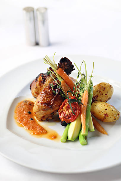 istock Grilled chicken legs and vegetables on a white plate 172884629