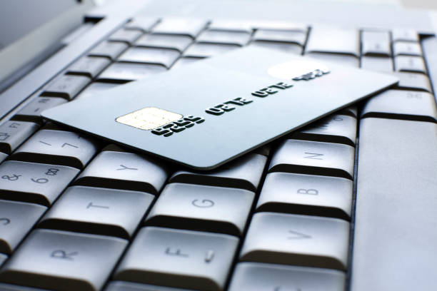 Blank credit card on an aluminium laptop.
