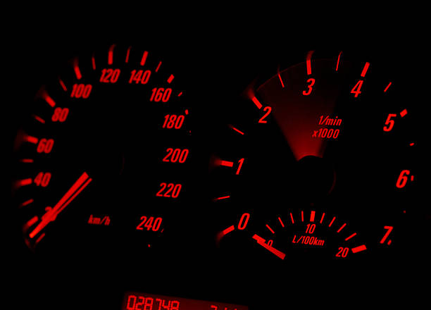 Car Dashboard - Engine Revving "Red illuminated car dashboard, with engine revving between 2000-4000rpm" Revving stock pictures, royalty-free photos & images