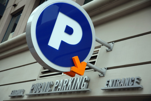 A busy parking garage in downtown San Diego is indicated with a parking sign.