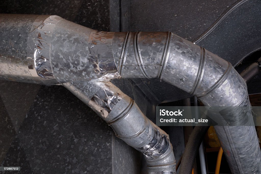 Basement Furnace Air Duct Pipes, horiz Typical US home basement installation of furnace ductwork and vent pipes. Air Duct Stock Photo