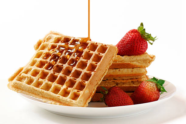 Waffles, hot maple syrup, and fresh strawberries
