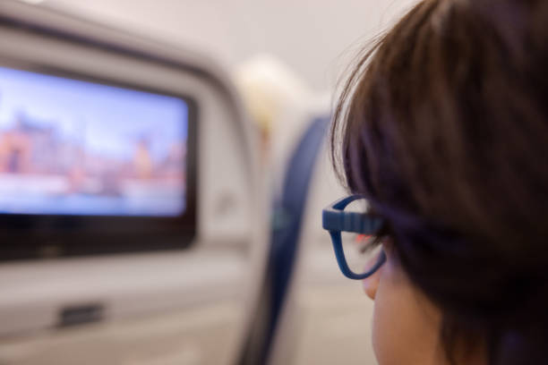 istock Multiracial boy watching a screen on a flight to Paris 1728909589