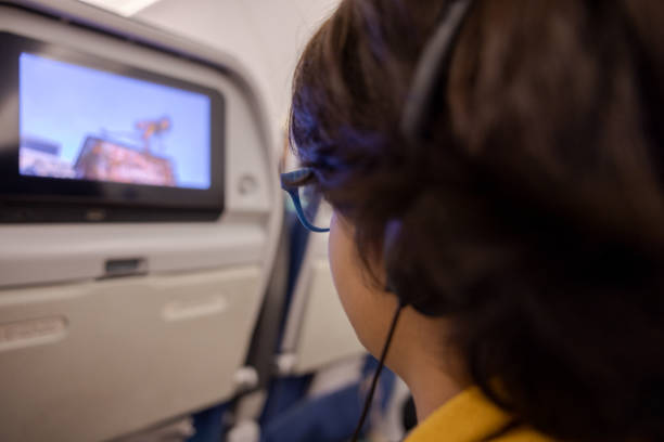 istock Multiracial boy watching a screen on a flight to Paris 1728909620