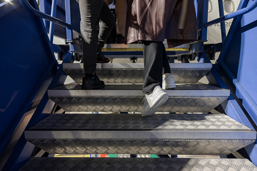 Boarding a commercial airplane, climbing the stairs to the plane