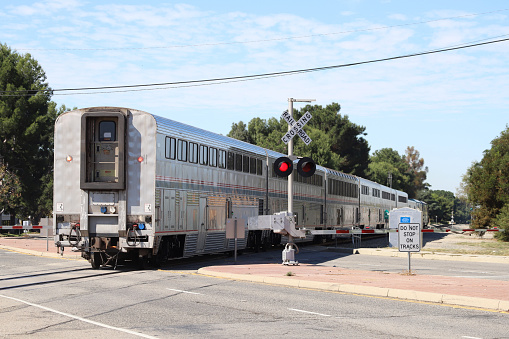 Amtrak Train Passing a Railroad Crossing.