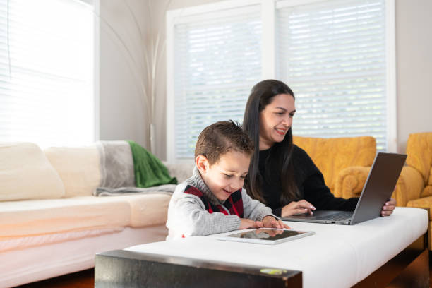 istock Latin mother and son using technology at home 1728921784