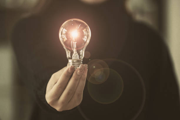 istock Woman holding a light bulb in her hand. 1728922924