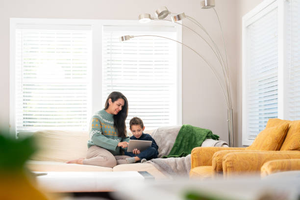 istock Latin mother and son using technology at home 1728925628