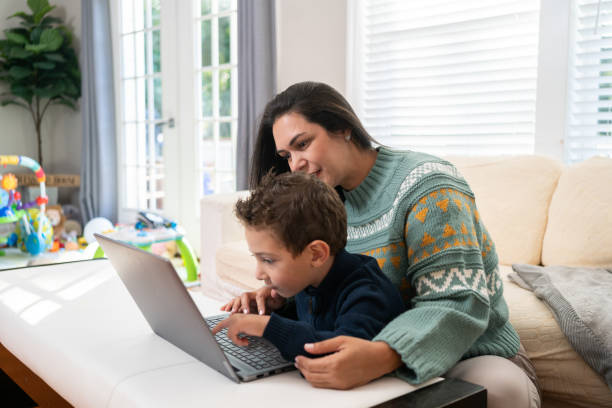 istock Latin mother and son using technology at home 1728928952