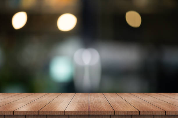 istock Empty wooden table top with lights bokeh on blur restaurant background. 1728933579