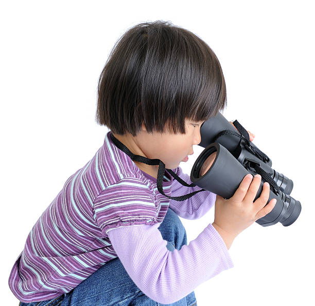 Little Child Looking Through Binoculars Backwards stock photo