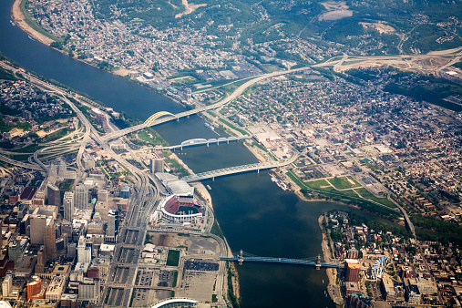 Aerial view of Cincinnati, Ohio on the left, and Covington, Kentucky on the right, with the Great American Ball Park on the Ohio River, highway and four major bridges.