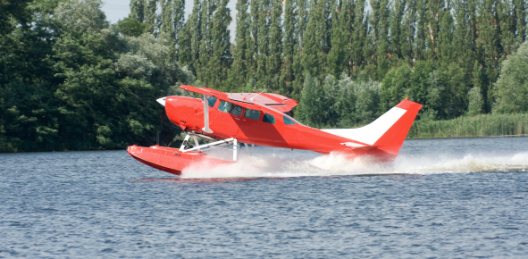 Red floatplane starting from the Spree River in Berlin