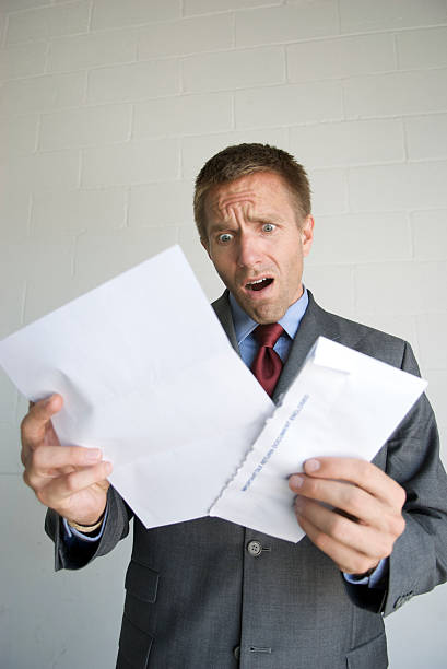 istock Shocked Businessman Opening Mail Envelope Bad News 172896108