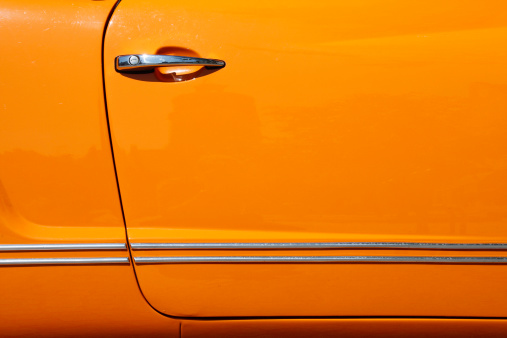 Detail of an orange vintage car door