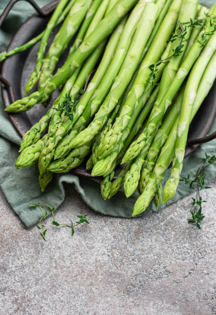 istock Fresh green asparagus on  concrete background. 1728969904