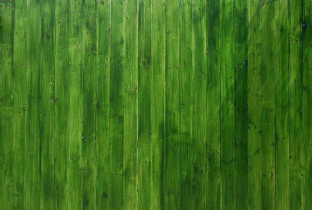 Vivid Green Wooden Texture Part of a freshly painted wooden fence.Photo was taken with a fixed 60mm macro lens. Look at my various wooden backgrounds in a thematic lb. palisade boundary stock pictures, royalty-free photos & images