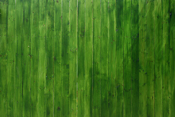 Vivid Green Wooden Texture Part of a freshly painted wooden fence.Photo was taken with a fixed 60mm macro lens. Look at my various wooden backgrounds in a thematic lb. green painted wood texture stock pictures, royalty-free photos & images