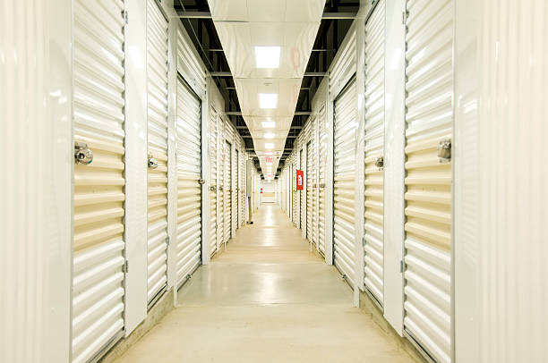 Maximum Storage Hall "Self Storage hall with lights, locks, door and concrete floor. Diminishing perspective" silo bag stock pictures, royalty-free photos & images