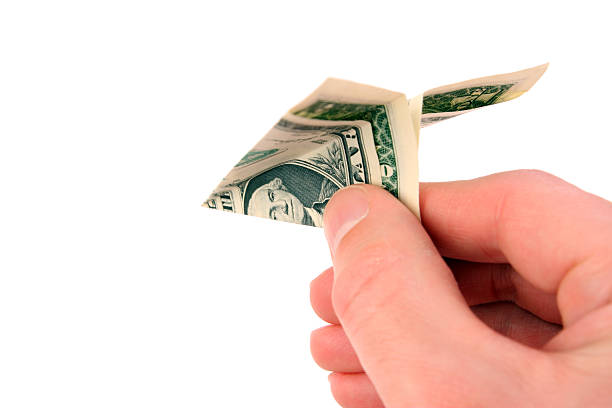 istock Throwing Money Away: Dollar Bill Paper Airplane Isolated on White 172898430