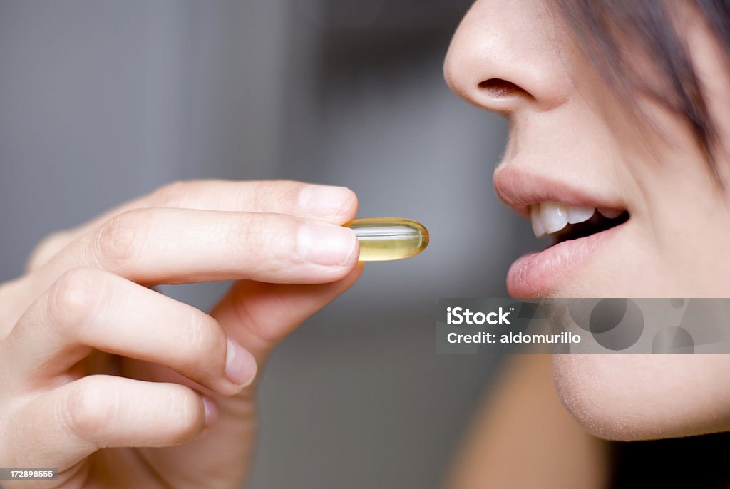 Woman taking medicine Pill Stock Photo