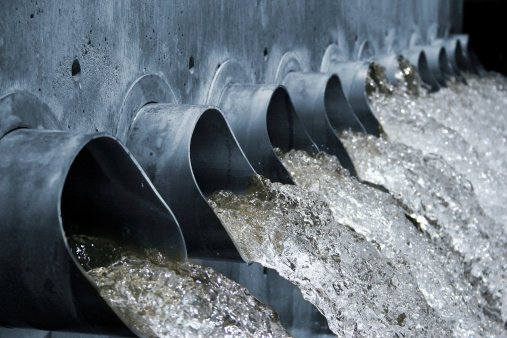 Water gushing out of steel spouts, high shutter speed, shallow depth of field