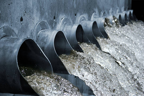 Water Spouts Gushing Water gushing out of steel spouts, high shutter speed, shallow depth of field sewer photos stock pictures, royalty-free photos & images