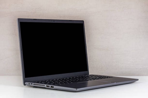 istock black mock-up on a laptop screen on a white table against a gray wall close-up 1728991050