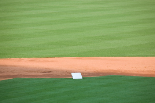 second base being installed on a professional baseball field