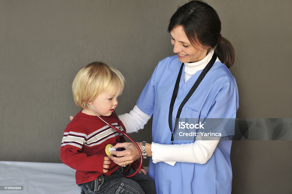 tummy noises nurse letting baby listen to his belly with a stethoscope 12-17 Months Stock Photo