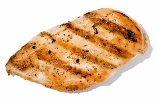 Broiled seasoned Chicken isolated on white.