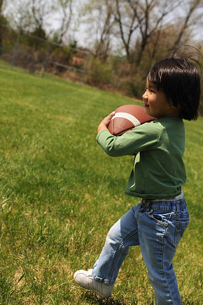 istock Toddler Running with Football 172901401