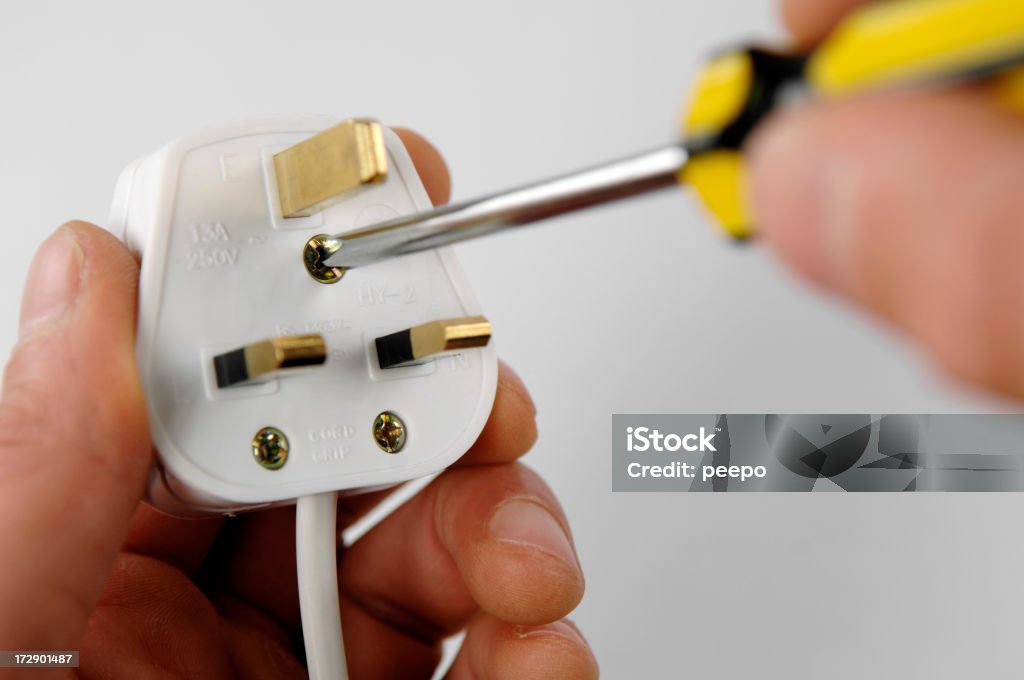 electrical series selective focus image of person holding plug Cable Stock Photo