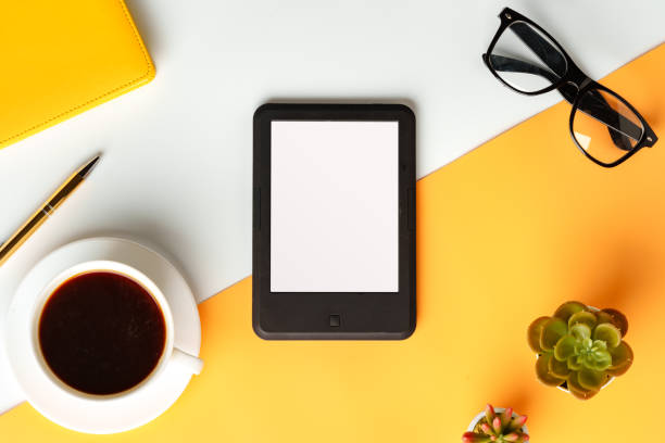 istock E-book reader with coffee cup and glasses on white and yellow background 1729017570