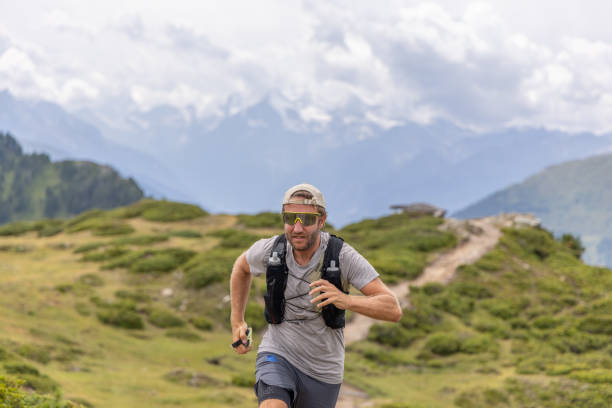 istock Trail runner ascends alpine path in Swiss mountain landscape 1729018328