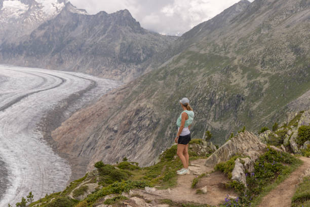 istock Female trail runner takes a break above glacier 1729018332