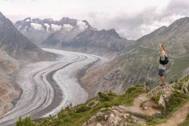 istock Trail runner pauses on mountain pass, looking at view 1729018335