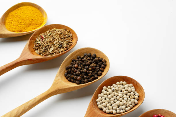 istock Wooden spoons with various spices isolated on white background 1729019446