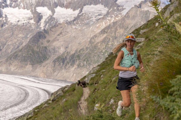 istock Female trail runner ascends alpine path in Swiss mountain landscape 1729019979