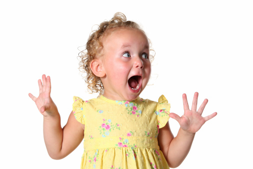 Little girl looks totally excited on a white background