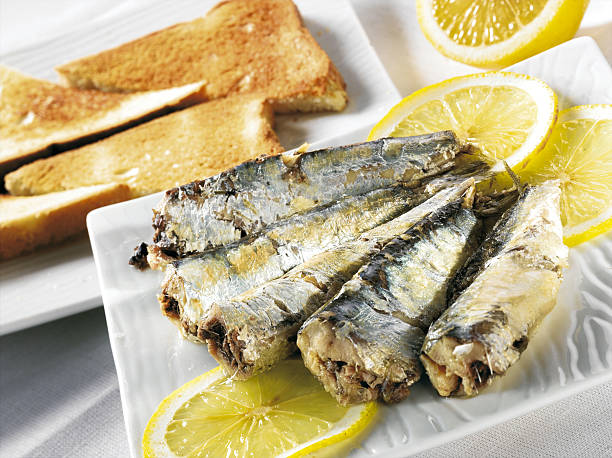 istock Cooked sardines on a plate with lemon slices 172902227