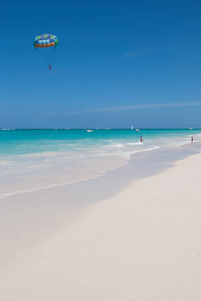 istock Tropical White Beach with Parasailers in Blue Sky 172902245